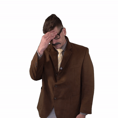 Man In Suit And Tie Holding Head In Pain GIF