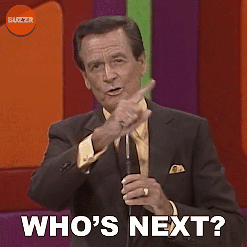 Man In Suit And Tie Holding Microphone Who's Next GIF