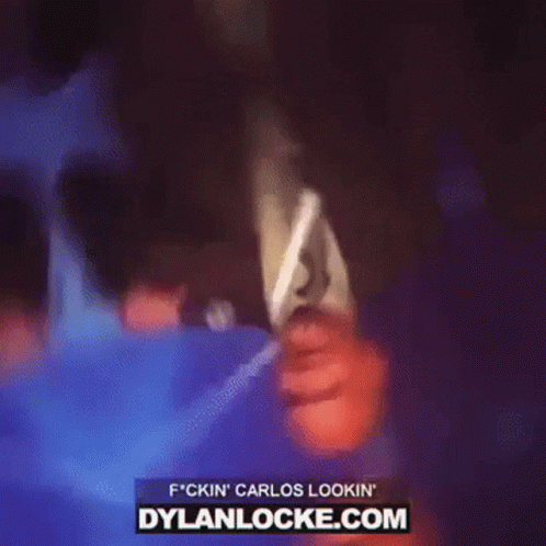 Man In Suit And Tie Holding Microphone With Dylanlocke.com GIF