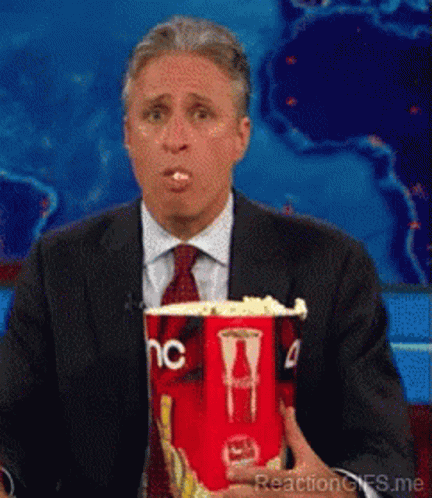 Man In Suit And Tie Holding Popcorn GIF