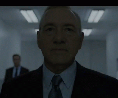 Man in Suit and Tie in Dark Room