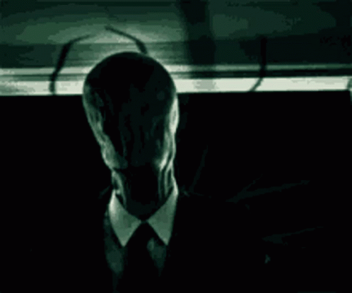 Man in Suit and Tie in Dark With Shadow
