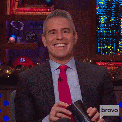 Man in Suit and Tie in Front of Bravo Screen