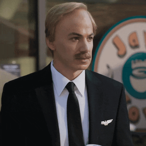 Man in Suit and Tie in Front of Coffee Shop