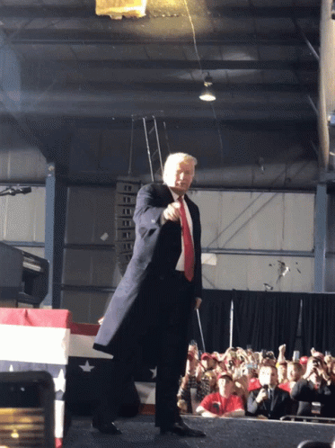 Man in Suit and Tie in Front of Crowd