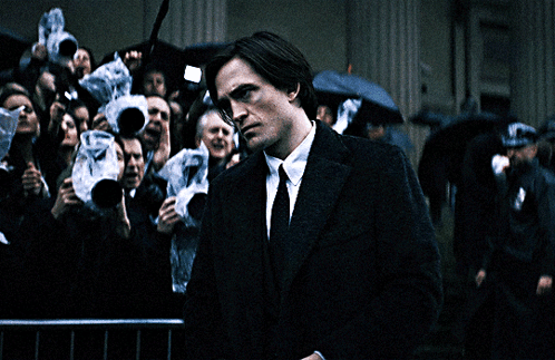 Man in Suit and Tie in Front of Crowd Taking Pictures