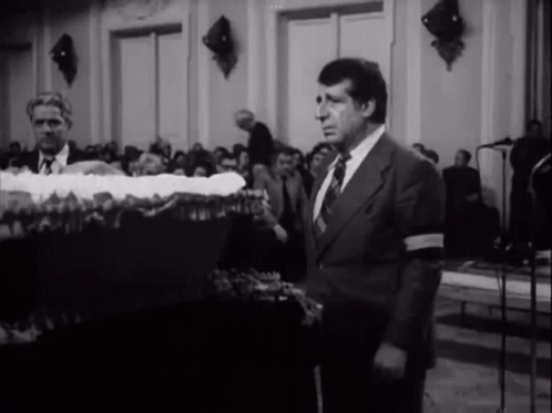 Man in Suit and Tie in Front of Crowd