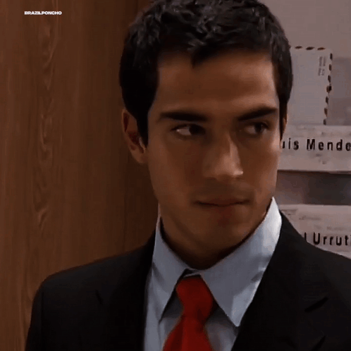 Man In Suit And Tie In Front Of Endez G Wall GIF