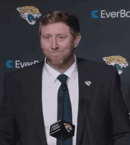 Man In Suit And Tie In Front Of EverBank Sign GIF