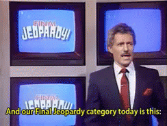 Man In Suit And Tie In Front Of Jeopardy Screen GIF