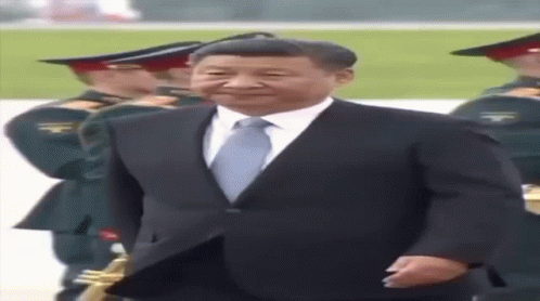 Man in Suit and Tie in Front of Military Band