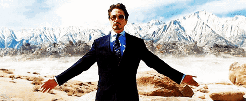 Man In Suit And Tie In Front Of Mountains GIF