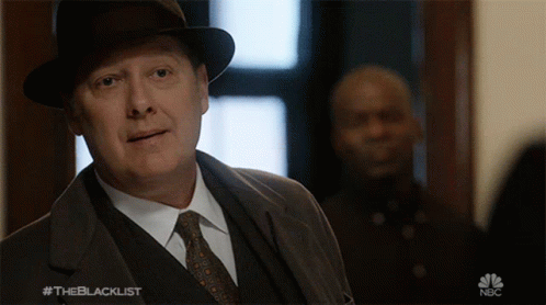 Man In Suit And Tie In Front Of NBC Sign GIF