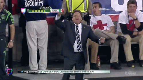 Man in Suit and Tie in Front of Security Screen
