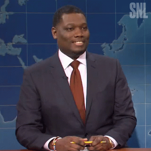 Man in Suit and Tie in Front of SNL Map