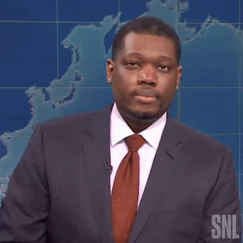 Man In Suit And Tie In Front Of SNL Map GIF