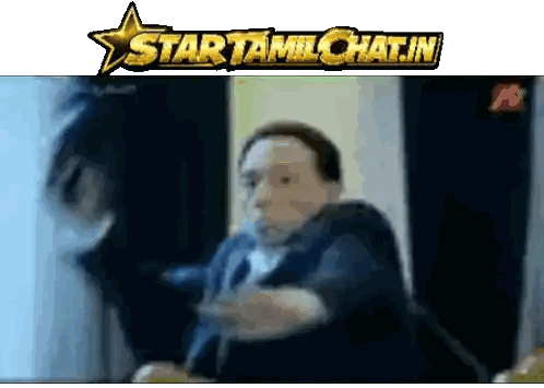 Man in Suit and Tie in Front of Startamilchat.in Sign