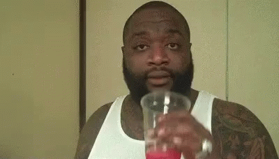 Man In Suit And Tie In Front Of Superstar Poster GIF