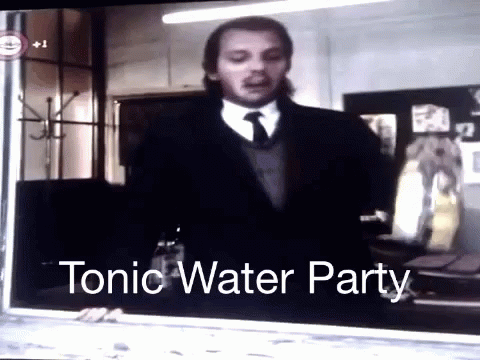 Man in Suit and Tie in Front of Tonic Water Party
