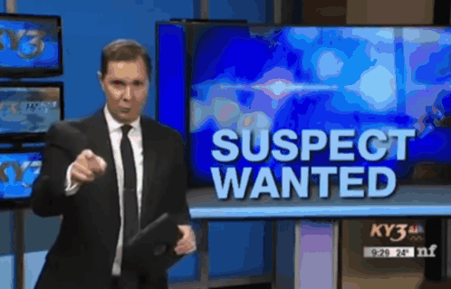 Man in Suit and Tie in Front Of Wanted Sign