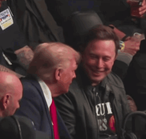 Man in Suit and Tie Laughing in Crowd