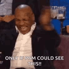 Man in Suit and Tie Laughing in Stadium