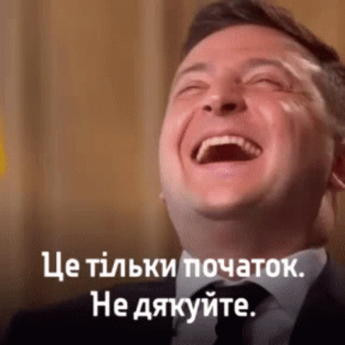 Man In Suit And Tie Laughing With Caption In Another Language GIF