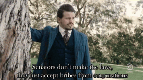 Man in Suit and Tie Leaning Against Tree Saying Senators