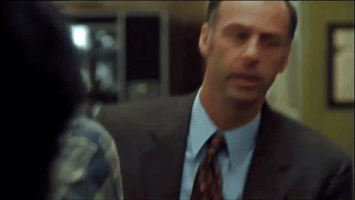 Man in Suit and Tie Looking at Another Man