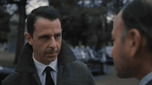 Man In Suit And Tie Looking At Another Man GIF