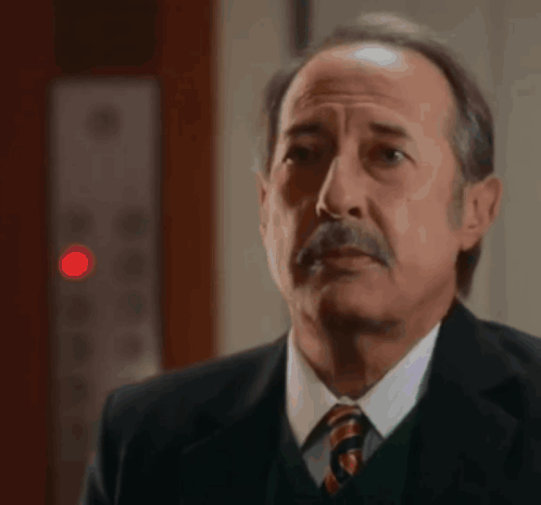 Man in Suit and Tie Looking at Something