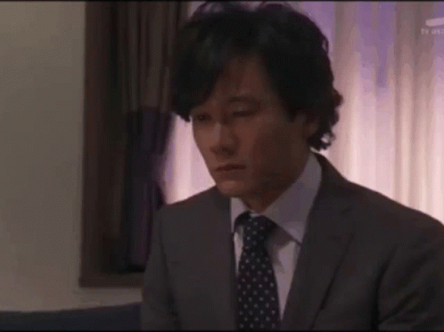 Man In Suit And Tie Looking Down GIF