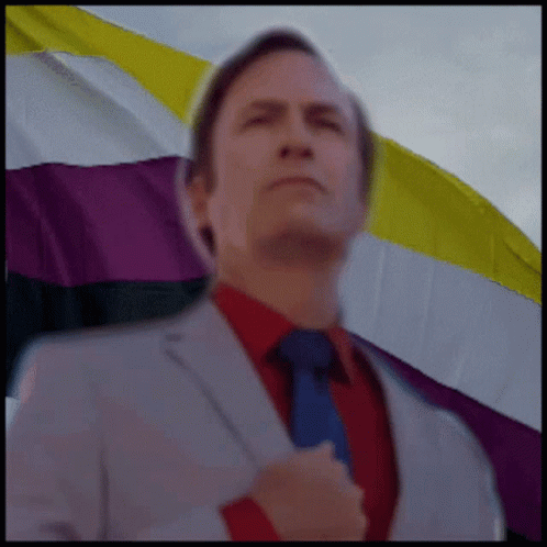 Man in Suit and Tie Looks at Camera