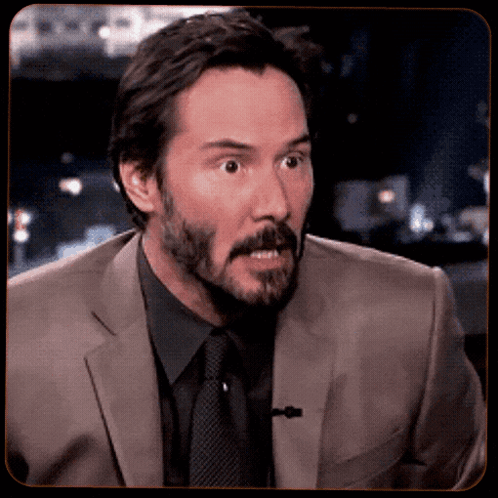 Man in Suit and Tie Looks Surprised