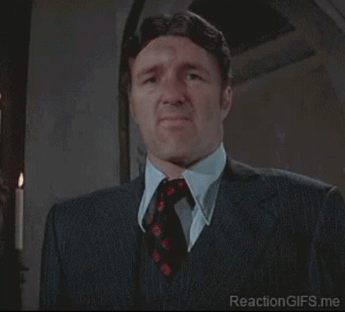 Man In Suit And Tie Making Funny Face GIF