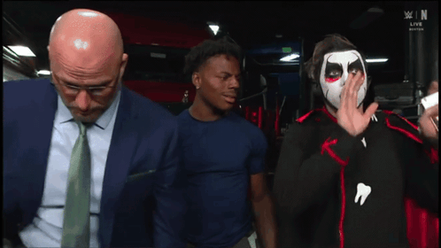 Man in Suit and Tie Next to Face Painted Man with You