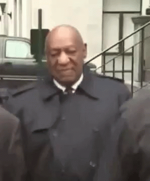 Man In Suit And Tie Next To Group GIF