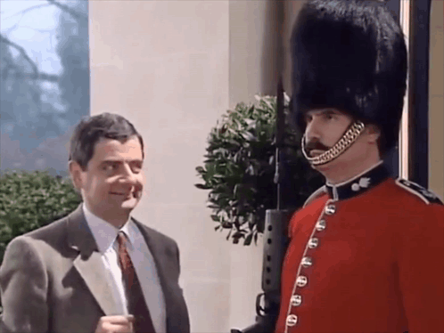 Man In Suit And Tie Next To Military Man GIF