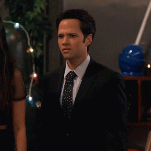 Man in Suit and Tie Next to Woman