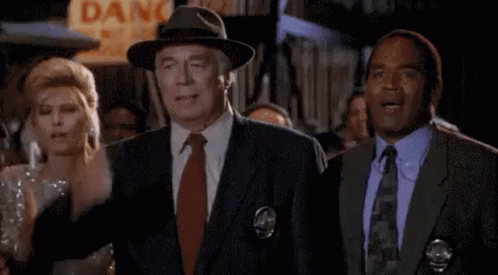 Man in Suit and Tie Next to Woman in Dress