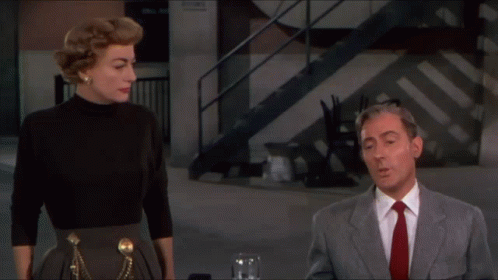 Man in Suit and Tie Next to Woman