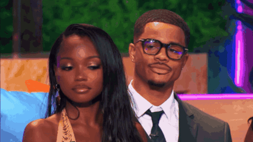 Man in Suit and Tie Next to Woman Wearing Glasses