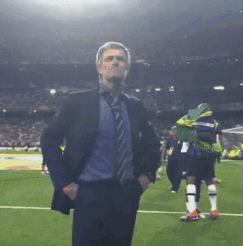 Man in Suit and Tie on Soccer Field