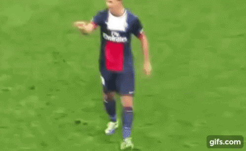 Man in Suit and Tie on Soccer Field With UEFA Logo
