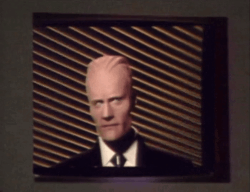 Man In Suit And Tie On TV GIF