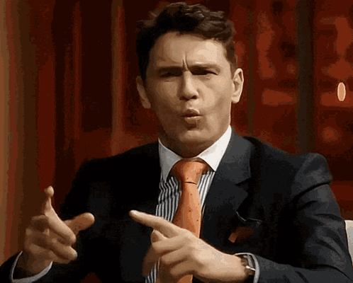Man In Suit And Tie Pointing GIF