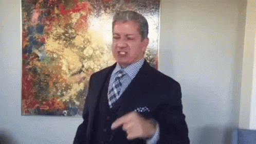 Man in Suit and Tie Pointing