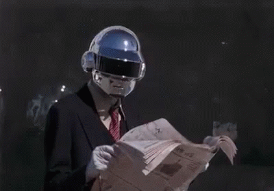 Man in Suit and Tie Reading Newspaper With Futuristic Helmet