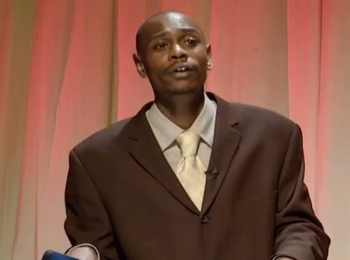 Man in Suit and Tie Red Curtain