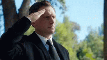 Man In Suit And Tie Saluting Tree GIF